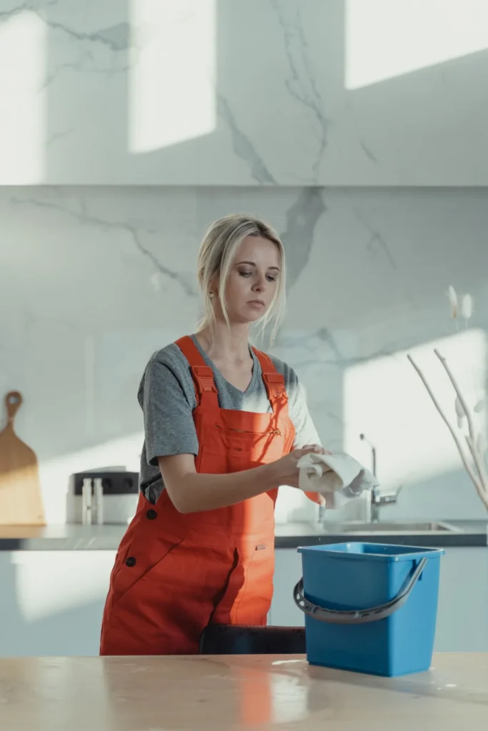 Cleaner wiping kitchen surfaces